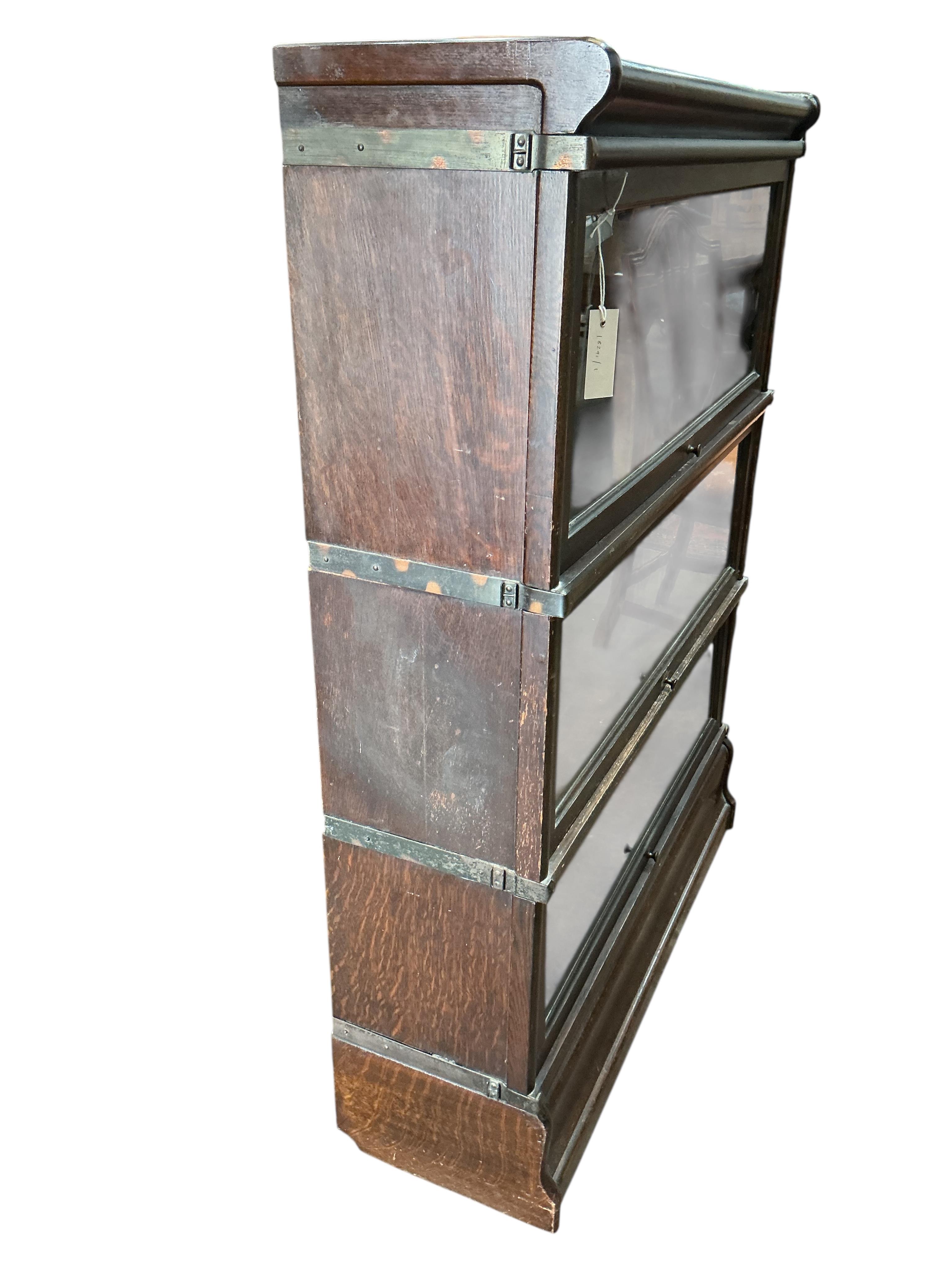 A Globe Wernicke oak three section bookcase, width 86cm, depth 27cm, height 116cm